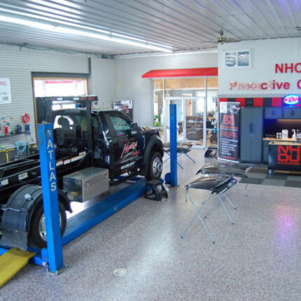 Pickup truck raised on a lift inside the NHOU shop in Chichester, New Hampshire
